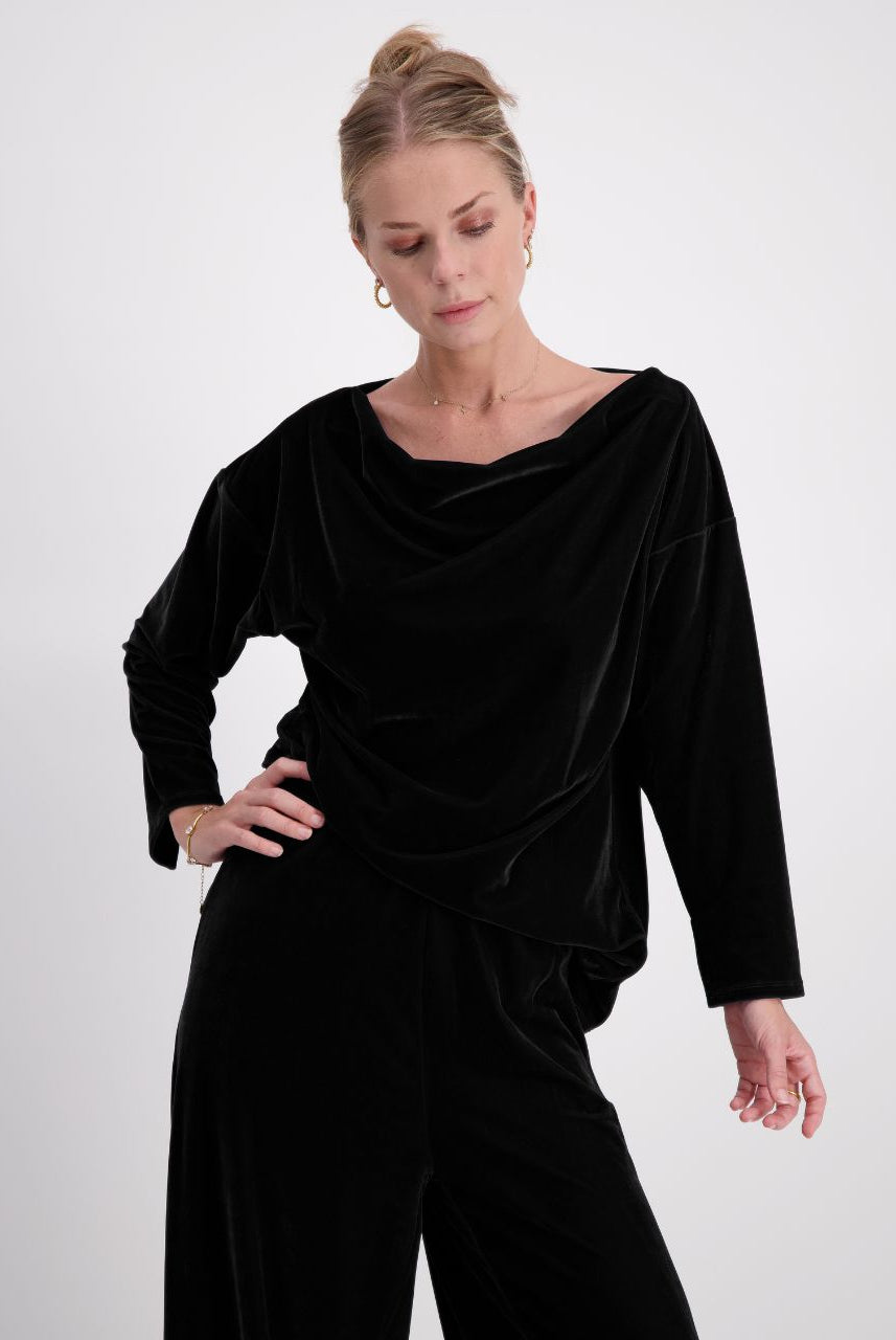 Emma Boat Neck Leaf Back Top in luxurious black velvet, featuring an elegant boat neckline, three-quarter length sleeves with split cuffs, and a distinctive leaf-back design. The top is shown styled against a light background, highlighting the plush texture and sophisticated draping.