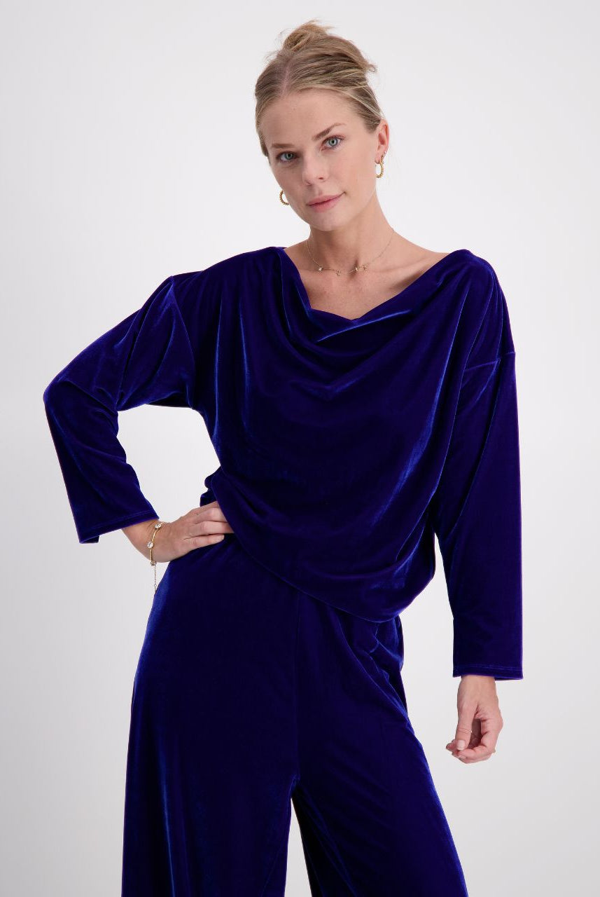 Emma Boat Neck Leaf Back Top in luxurious cobalt blue velvet, featuring an elegant draped neckline, three-quarter length sleeves with split cuffs, and a sophisticated leaf design on the back, photographed against a light background.