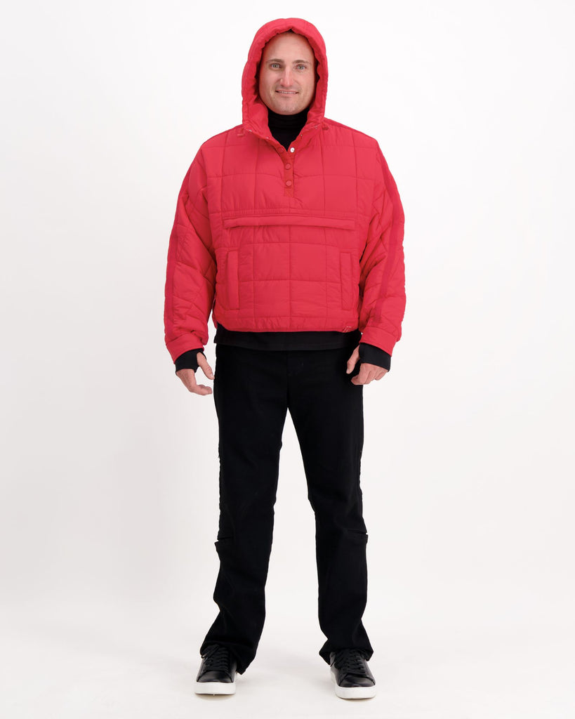 Standing male is wearing a magenta red puffer jacket over black pants. Christina Stephens Adaptive Clothing Australia.