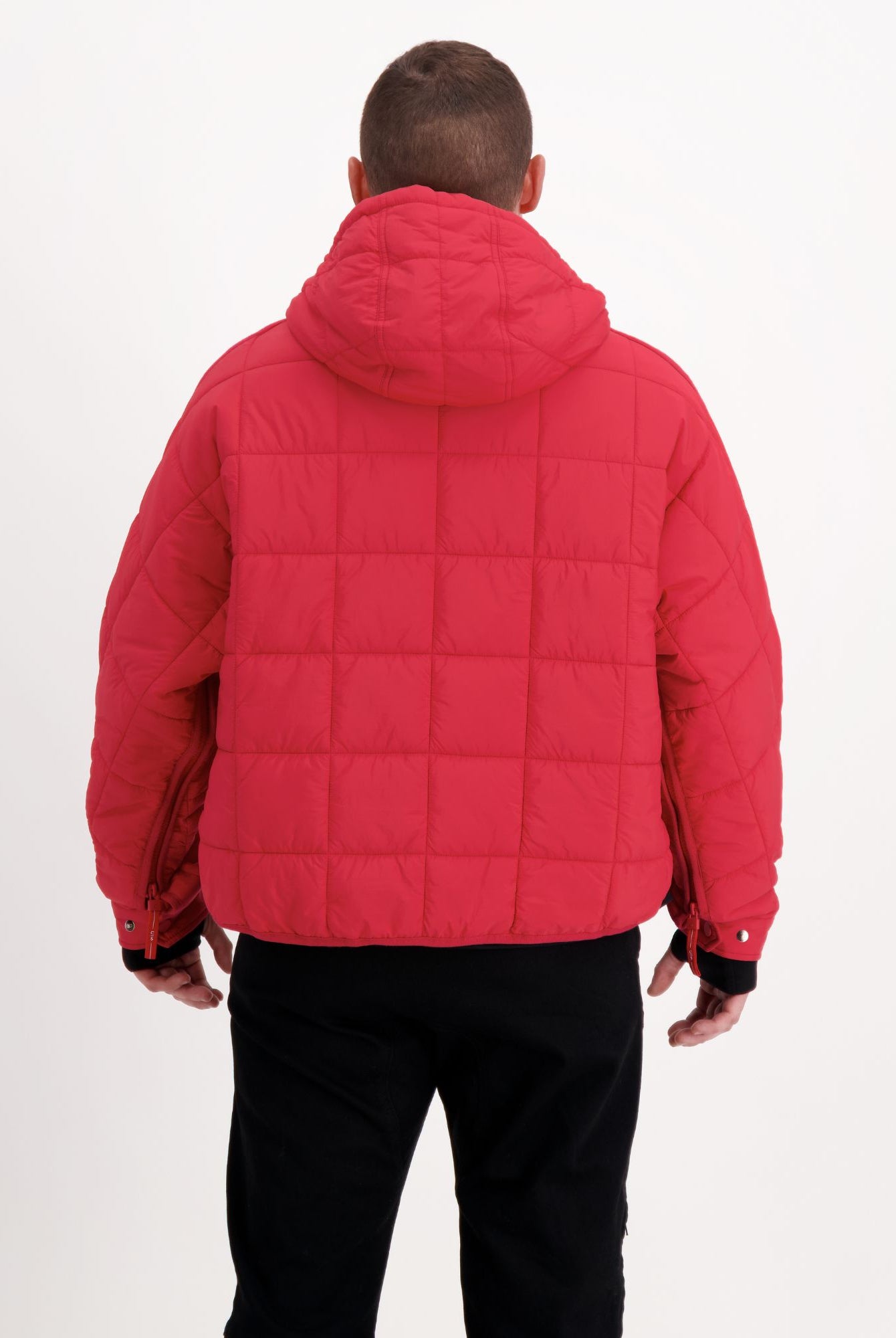 Elly Universal Puffer Jacket shown from back view in vibrant red, featuring quilted design, hooded neckline, and adaptive fit. Comfortable, lightweight puffer with spacious cut, ideal for wheelchair users, photographed against white background.