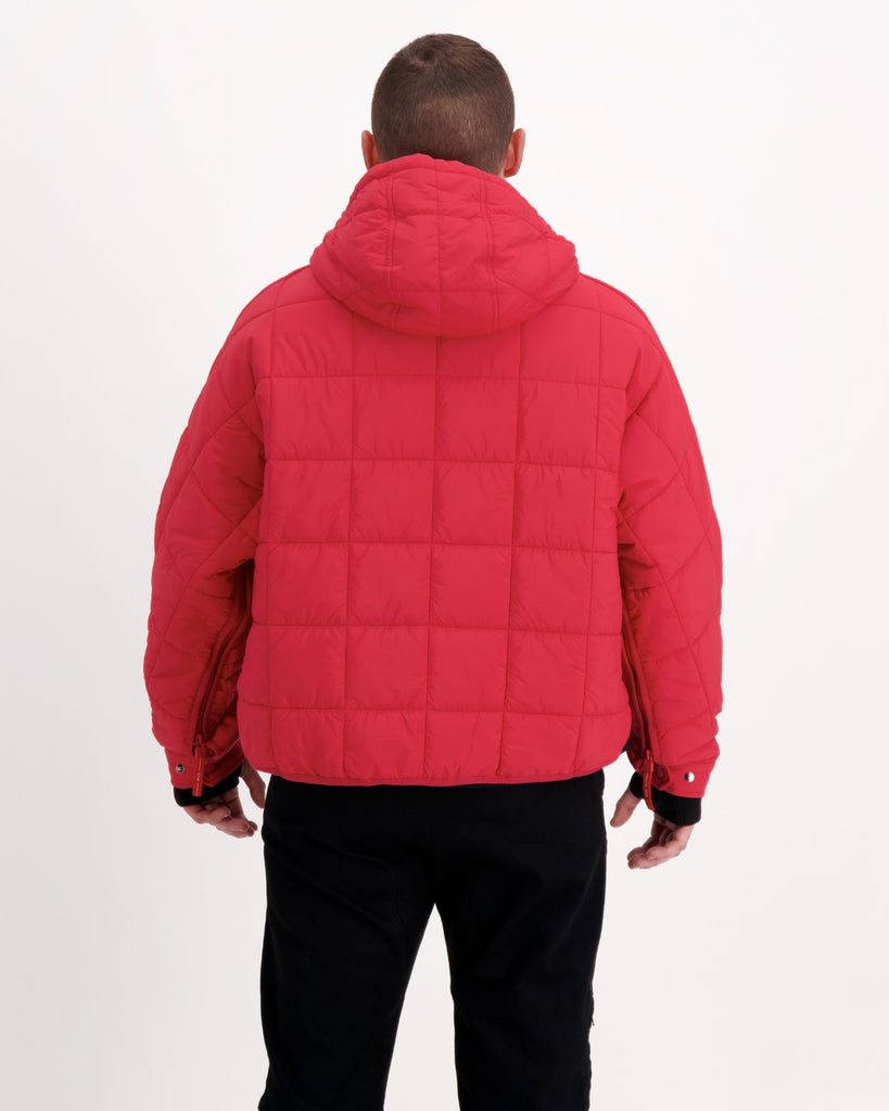 Standing male is wearing a magenta red puffer jacket over black pants. Christina Stephens Adaptive Clothing Australia.