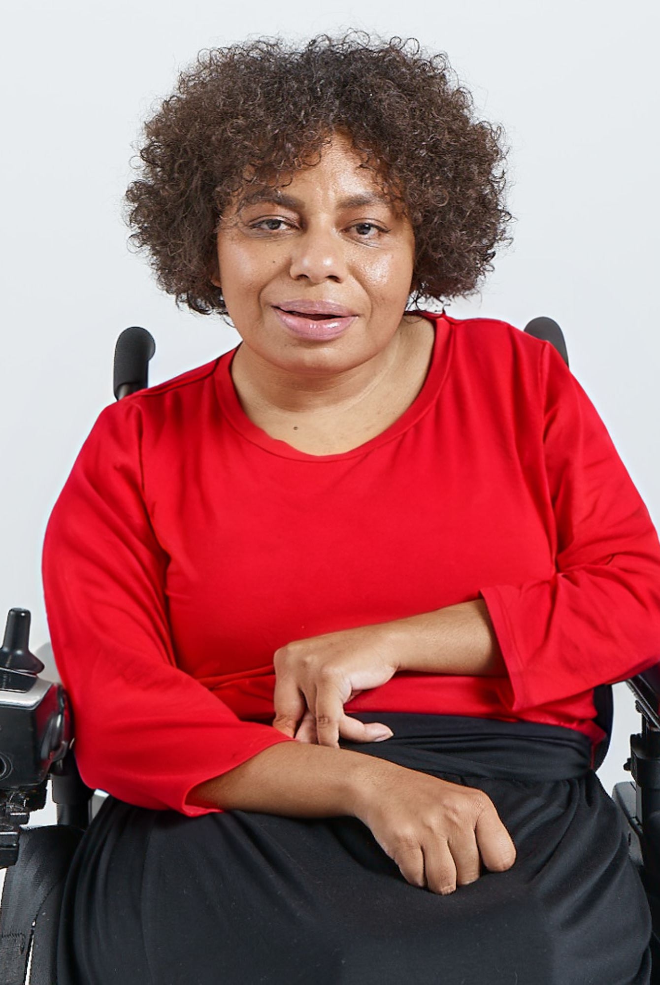 3/4 Sleeve Leaf Back T-Shirt shown in vibrant red, worn by a model seated in a wheelchair against a white background. The shirt features a classic round neckline and comfortable three-quarter length sleeves, demonstrating its adaptable and stylish design.