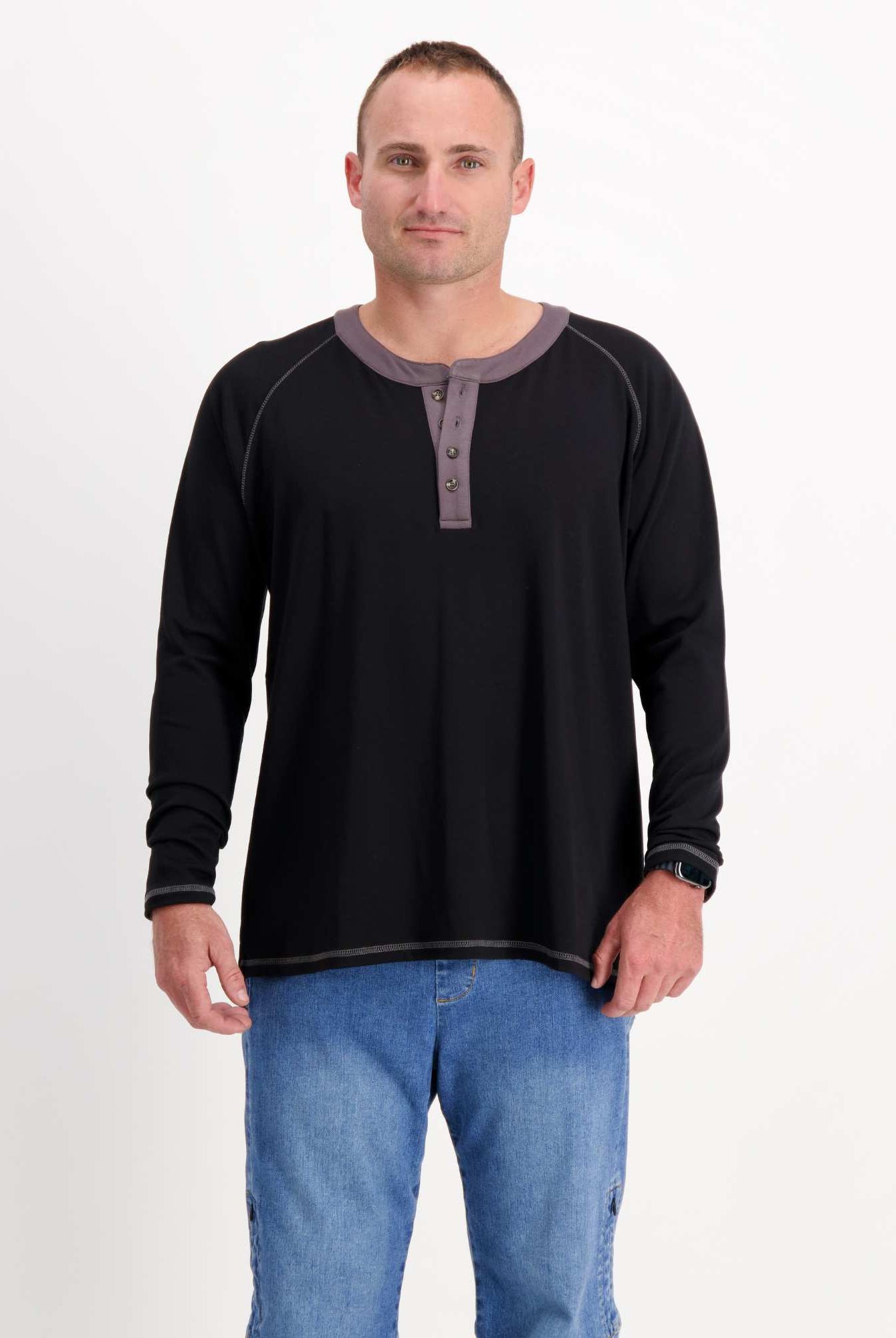Sir Lord Raglan T-Shirt in classic black with gray contrast henley collar and long sleeves, worn with blue jeans against white background, showcasing comfortable A-line fit and casual yet refined styling.