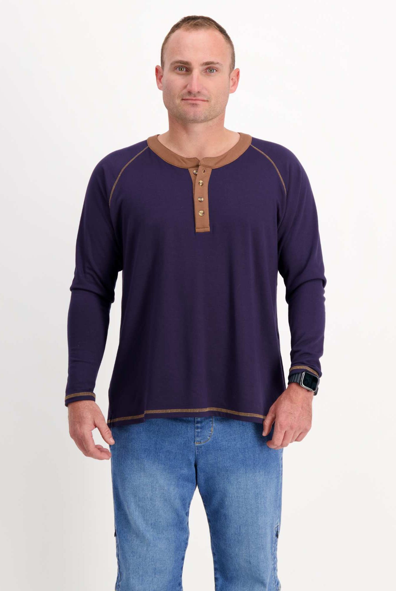 Sir Lord Raglan T-Shirt shown in navy blue with brown henley collar and contrast stitching, styled on a model with blue jeans. Long sleeve classic A-line design features raglan sleeves and a three-button placket for casual sophistication.