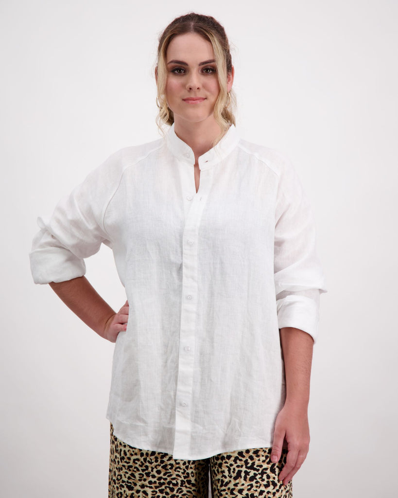 Standing female wearing a grandfather collar white linen shirt. Christina Stephens Adaptive Clothing Australia. 