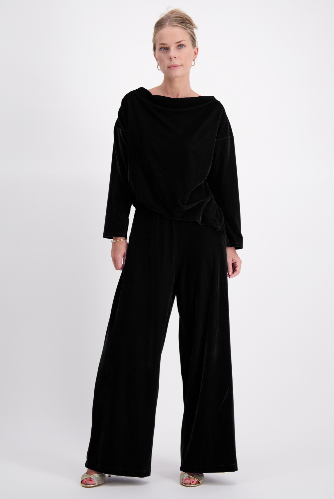 Jessie Wide Leg Velvet Pants shown in luxurious black velvet, featuring a relaxed silhouette with full-length wide legs, paired with a matching loose-fit velvet top. Elegant evening wear displayed against a light background, styled with metallic sandals.