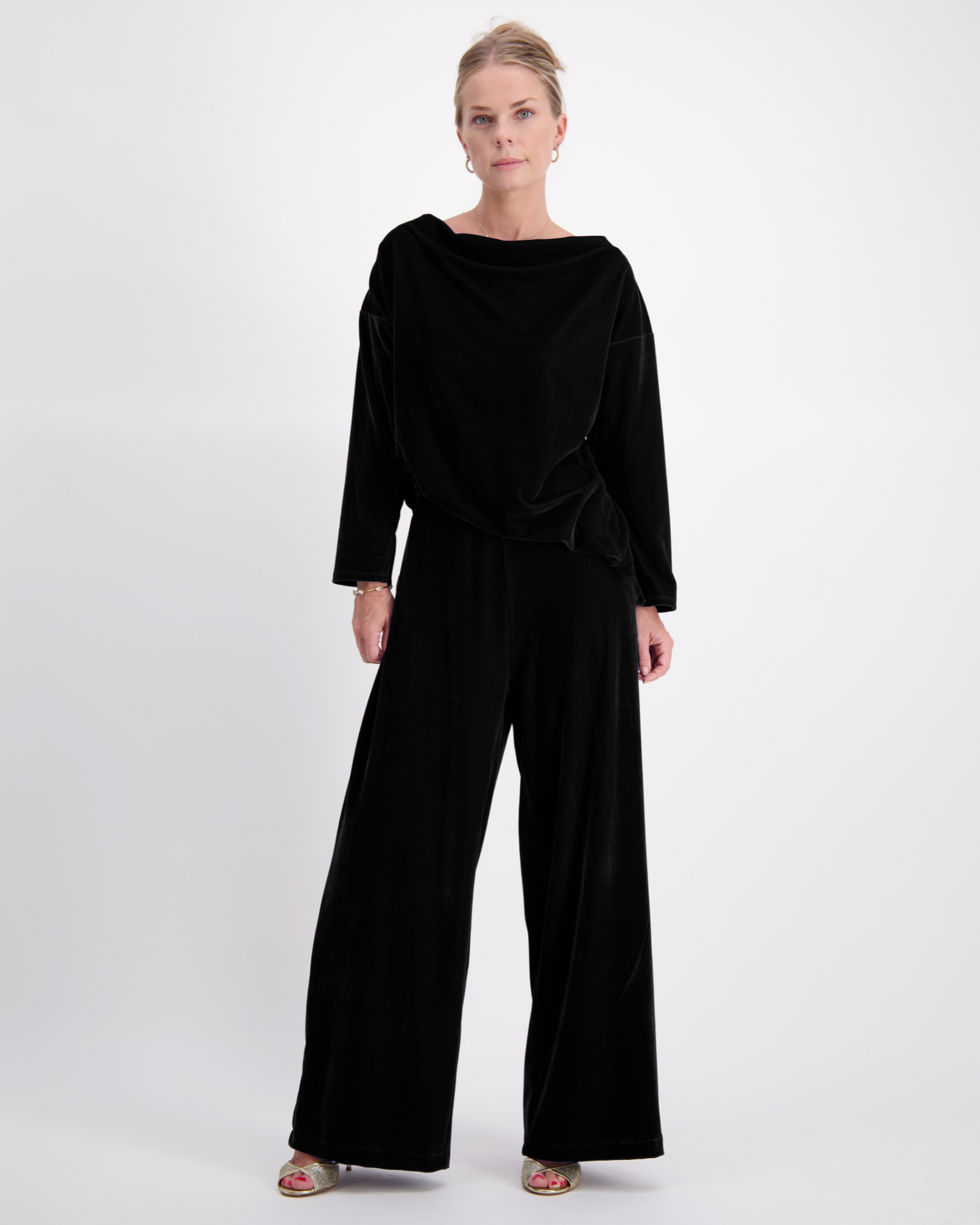 Jessie Wide Leg Velvet Pants shown in luxurious black velvet, featuring a relaxed silhouette with full-length wide legs, paired with a matching loose-fit velvet top. Elegant evening wear displayed against a light background, styled with metallic sandals.