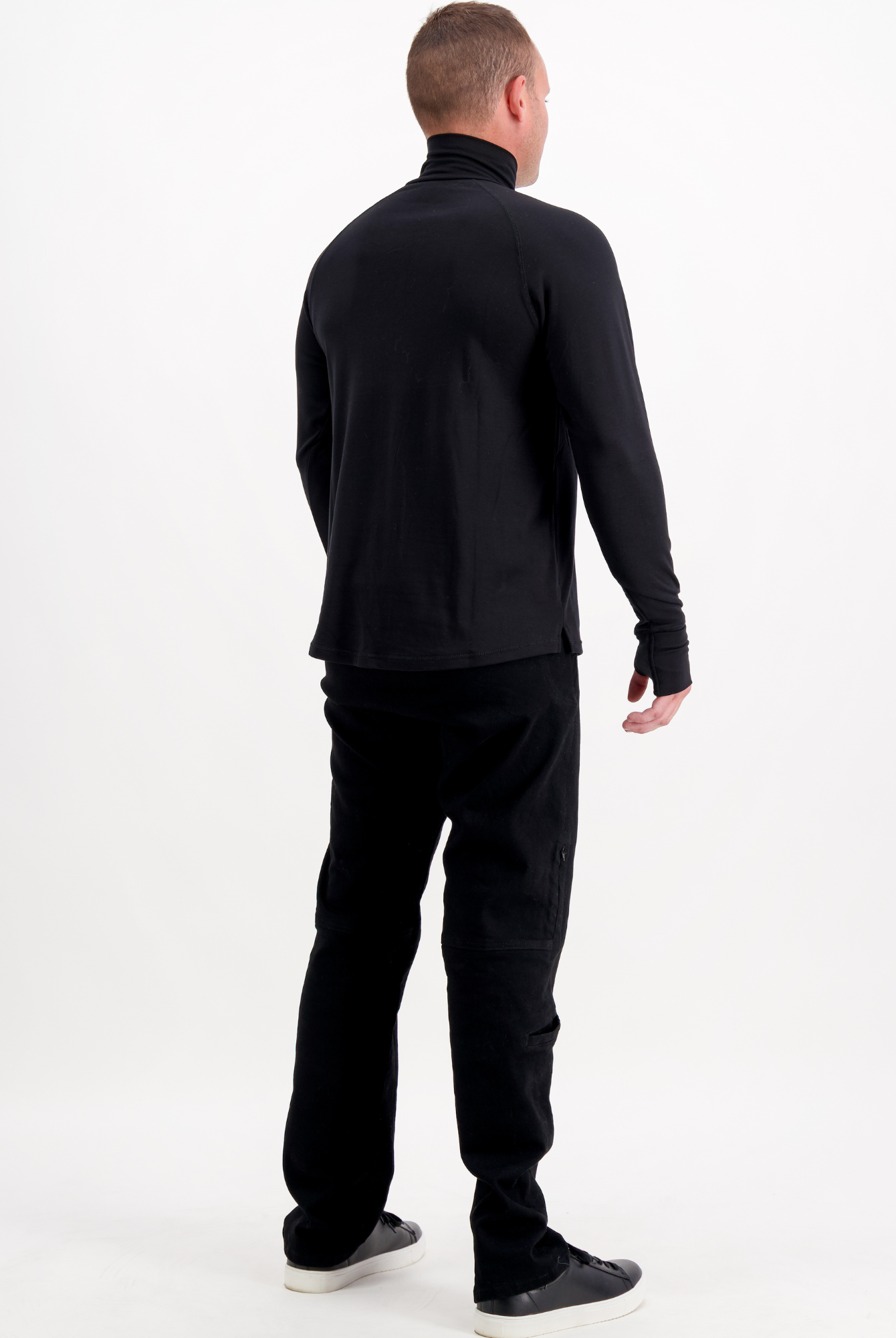 Back view of the Louis Thermal Top in classic black, showing full-length sleeves and a turtleneck design. The thermal top is styled with matching black pants and casual sneakers against a white background, demonstrating its versatile everyday wear appeal.
