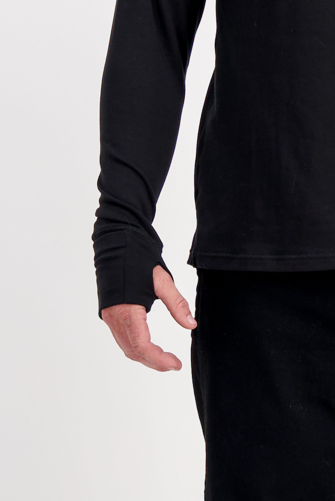 Louis Thermal Top shown with extended sleeves featuring thumb holes for added warmth and comfort. Close-up view of the black thermal top's sleeve detail, demonstrating the adaptive design suitable for both seated and standing wear.