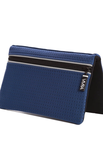 The VIVRA 'Base' waist bag in royal blue, perforated wallet with a black trim and zipper, adorned with a visible brand tag that says' Vivra', standing upright against a white background