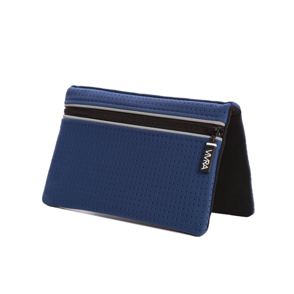 The VIVRA 'Base' waist bag in royal blue, perforated wallet with a black trim and zipper, adorned with a visible brand tag that says' Vivra', standing upright against a white background