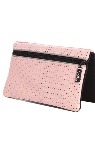 The VIVRA 'Base' waist bag in pastel pink, perforated wallet with a black trim and zipper, adorned with a visible brand tag that says' Vivra', propped up against a white background