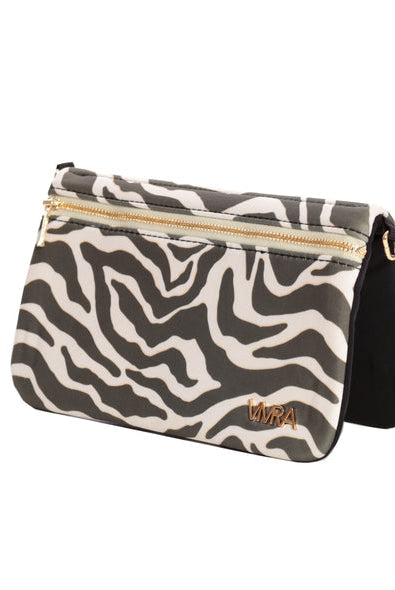 The VIVRA 'Chic' waist bag with a zebra print pattern and gold zipper detailing, featuring a brand emblem in gold that says, 'Vivra', angled upright against a white backdrop.