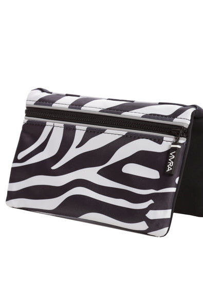The VIVRA ‘Vivid’ waist bag in a striking black and white abstract zebra stripe pattern, a black zipper, and a brand tag that says, ‘Vivra’, presented against a white backgroun