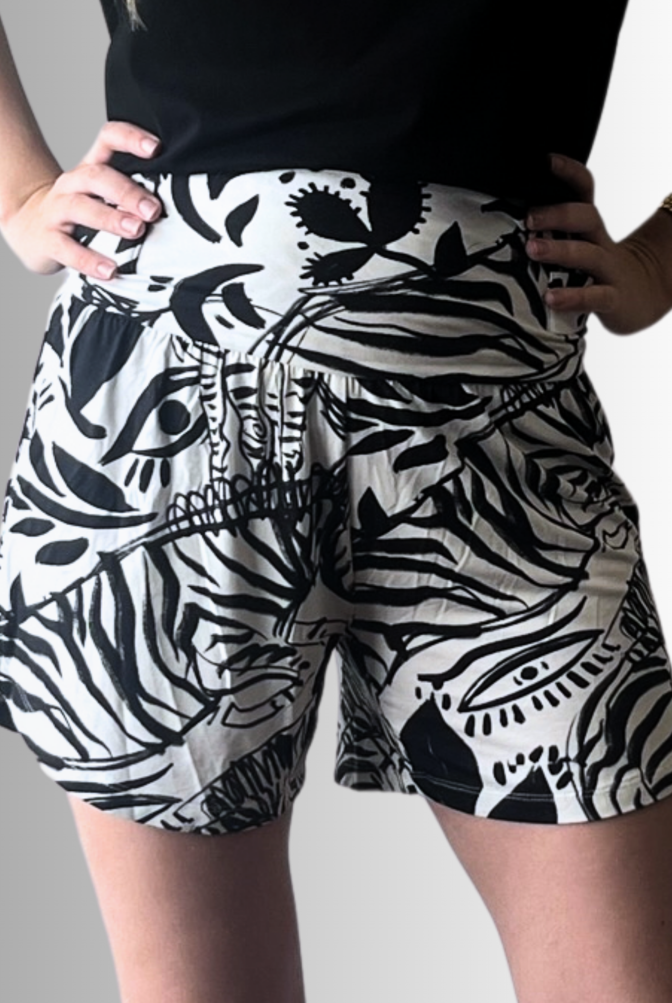 Shelley Adaptive High-Rise Shorts featuring a bold black and white abstract floral print with wide pull tabs and extra-wide waistband. The shorts showcase a modern silhouette with a comfortable high-rise fit against a light studio background.