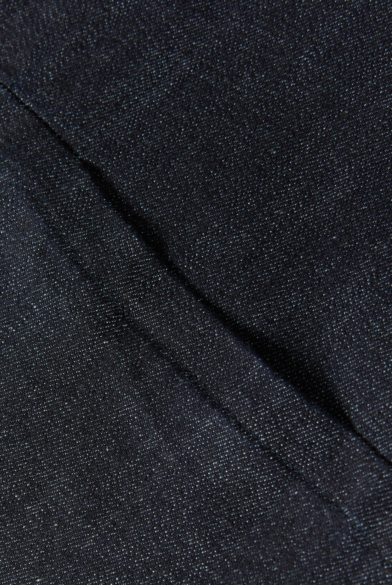 Close-up detail of dark blue fabric and seam on Women's Seated Stretch Pant - Indigo (Dark Blue).