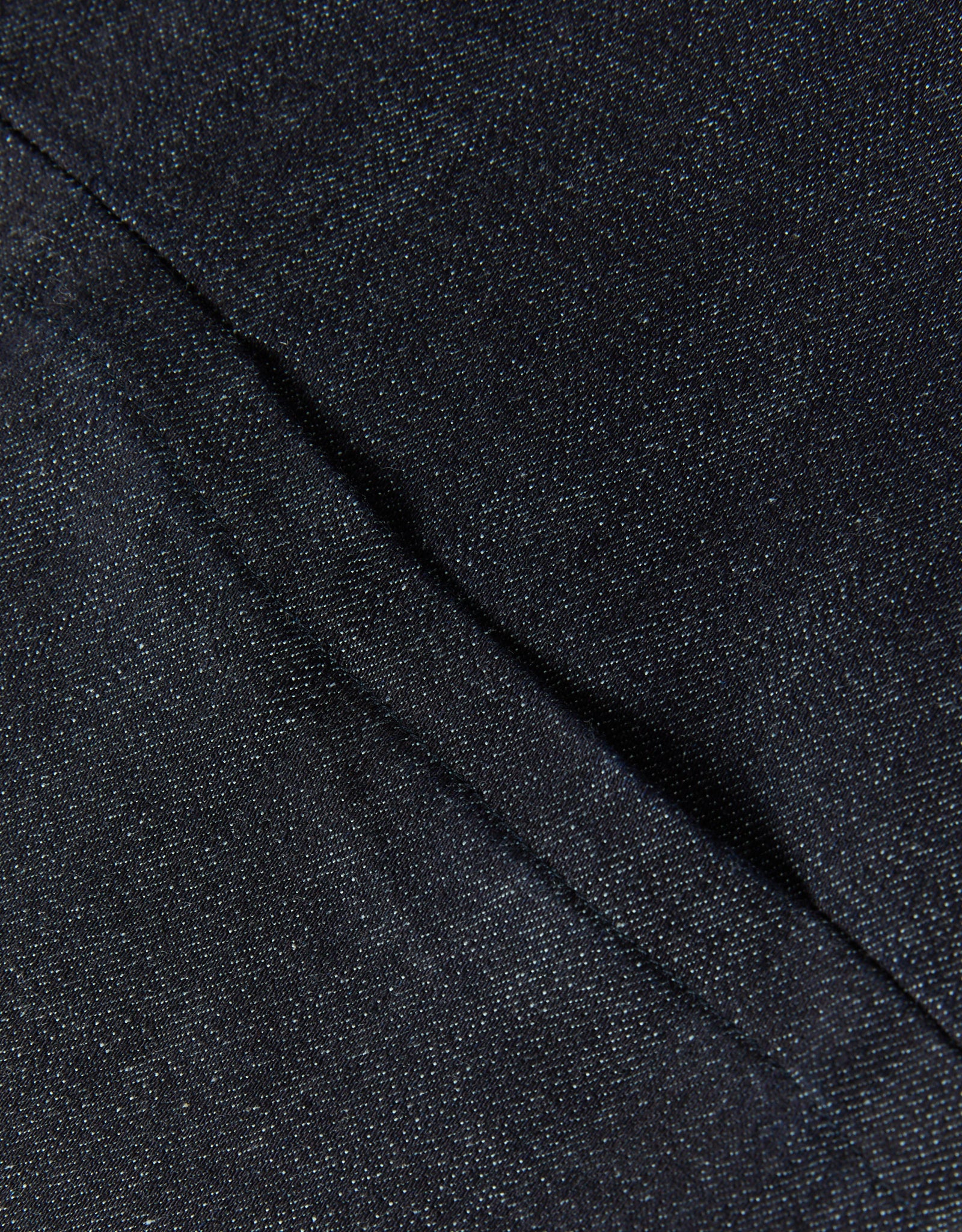 Close-up detail of dark blue fabric and seam on Women's Seated Stretch Pant - Indigo (Dark Blue).