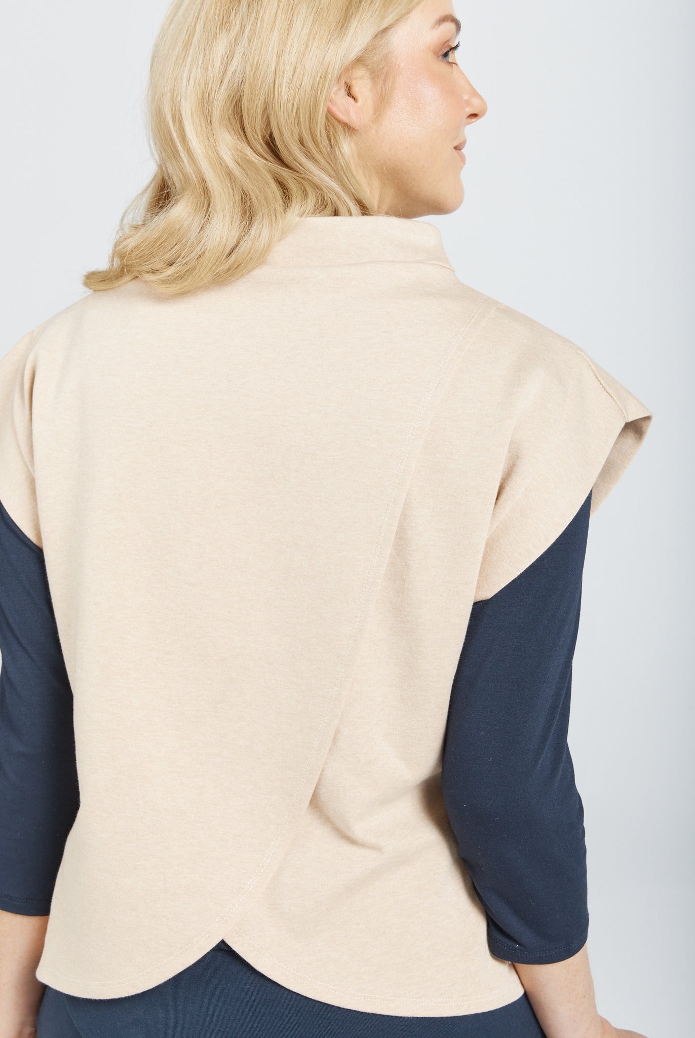 Leaf Back Blouse shown from behind, featuring a distinctive overlapping leaf-inspired design in beige with navy sleeves. The blouse showcases elegant Asian-influenced styling with a unique crossover back detail, photographed against a white background.