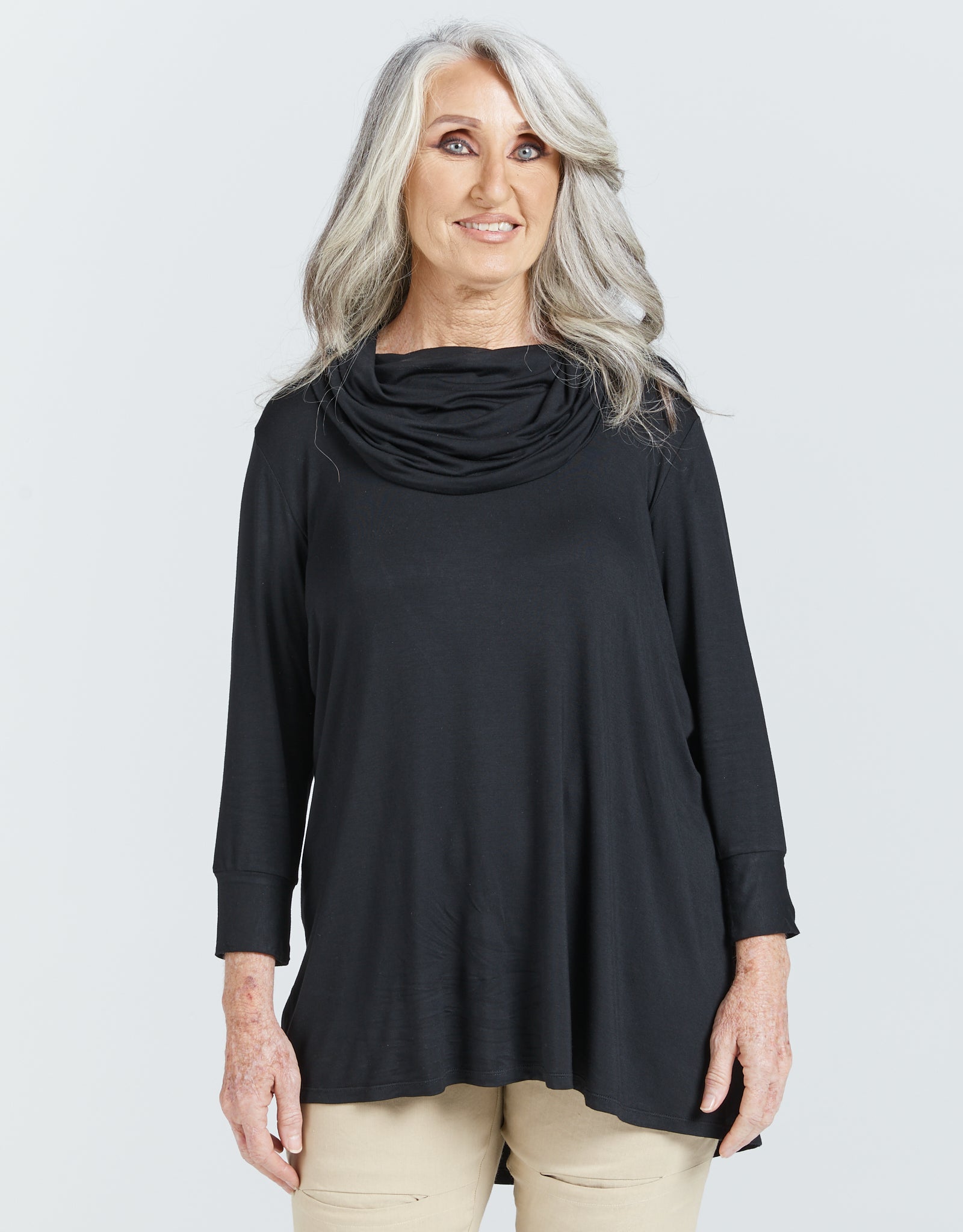 Cowl Neck Leaf Back Top in classic black bamboo fabric with elegant draped neckline and 3/4 sleeves, shown in a studio setting against a white background. The top features a relaxed fit with a subtle back split detail and modesty layer.