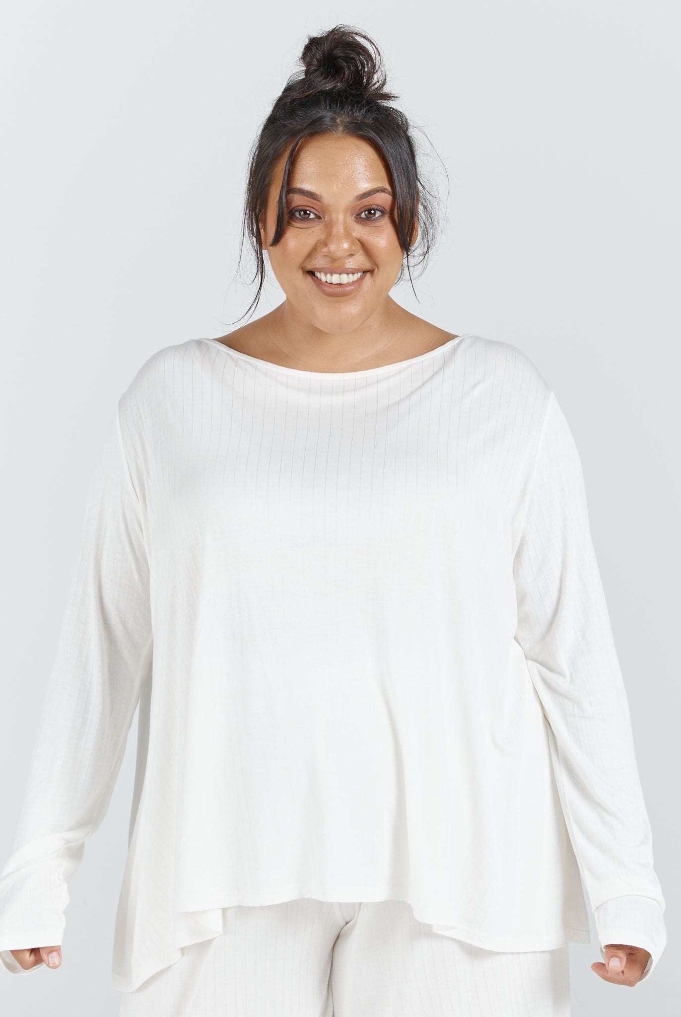 Essensual PJ Top in pure white, featuring a relaxed boat neckline, long sleeves, and flowing fabric design for comfortable nightwear. The loose-fitting top has a curved hemline and casual drape, perfect for peaceful rest and lounging.