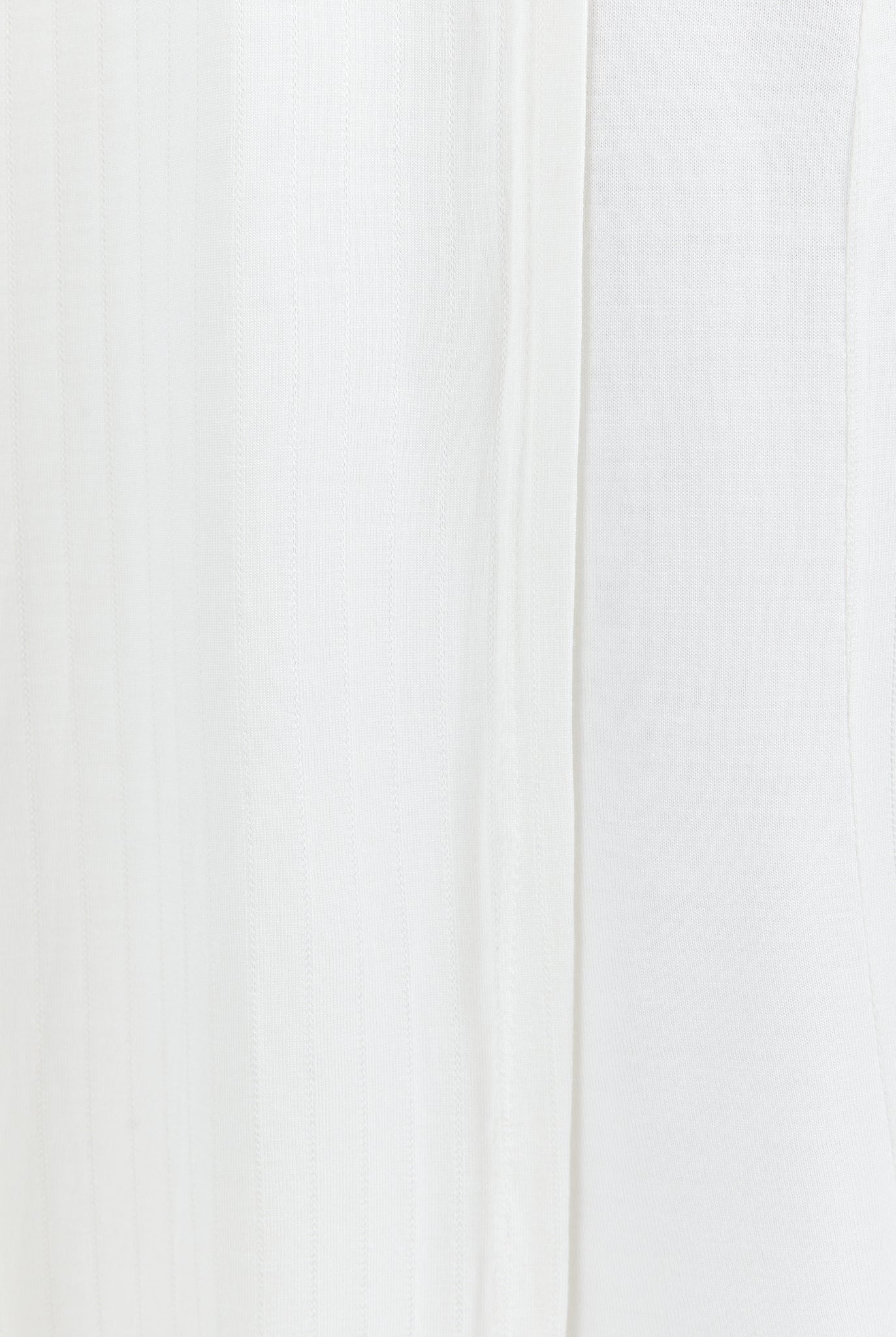 Essensual PJ Top in pure white fabric, featuring a soft, flowy texture with subtle vertical seam detail. This elegant sleepwear piece showcases a minimalist design perfect for comfortable nighttime wear.