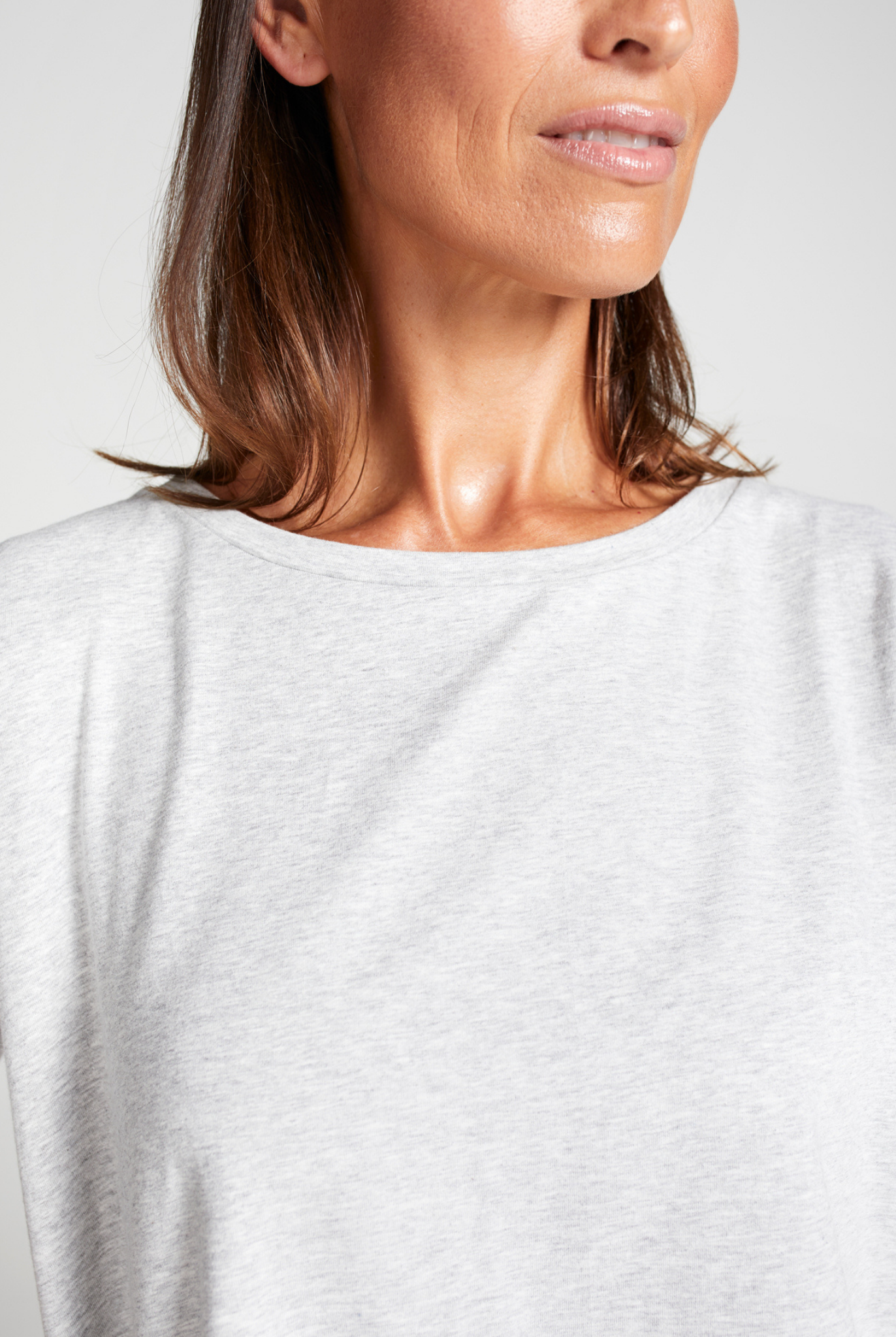 Close-up view of Short Sleeve Leaf Back T-Shirt in crisp white, featuring a classic round neckline and comfortable relaxed fit, showcasing the soft fabric texture and casual elegant design