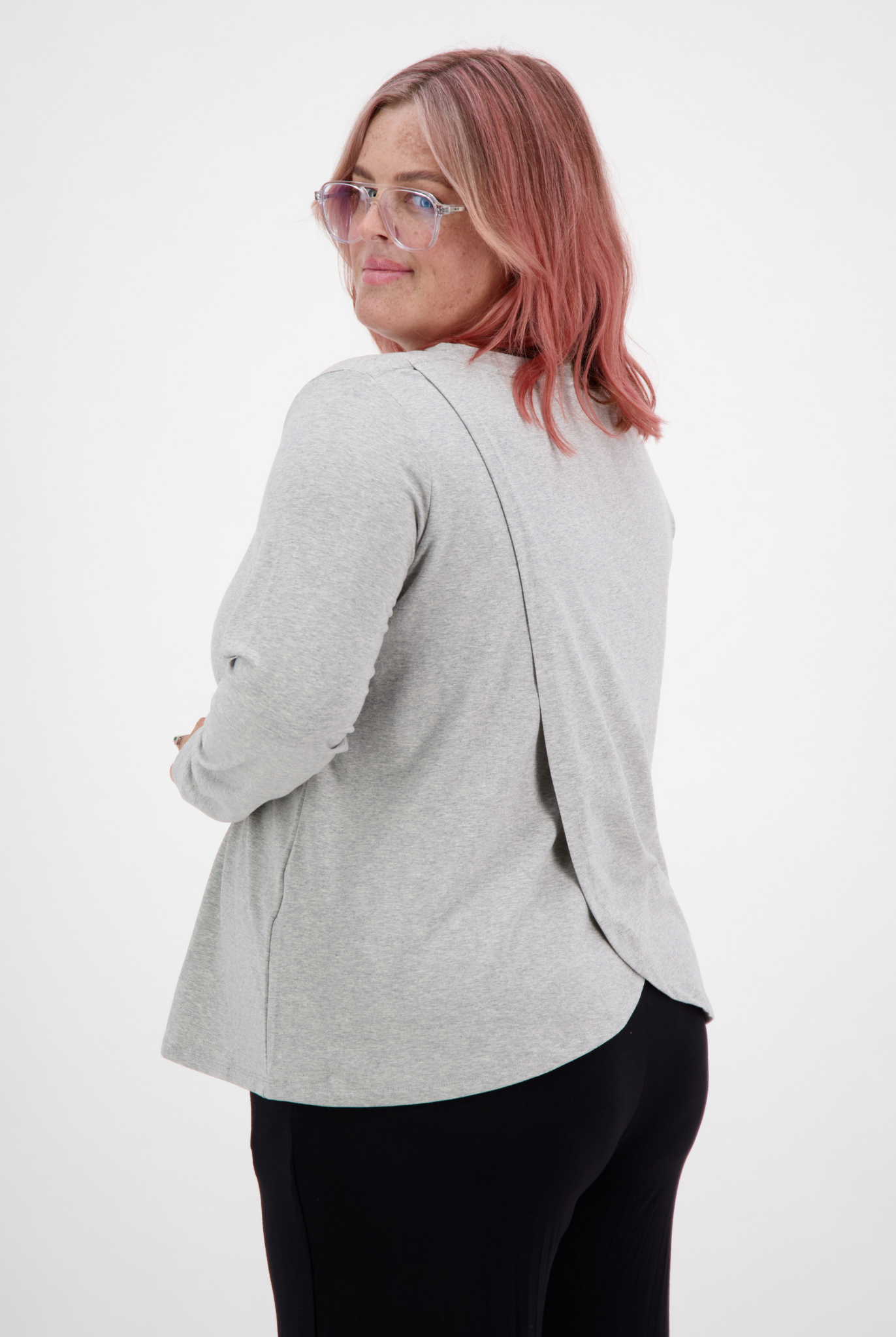 Long Sleeve Leaf Back T-Shirt shown from behind, featuring a stylish grey fabric with unique split back design, styled on a model against white background. Casual yet elegant wardrobe essential with modern tailoring and comfortable fit.