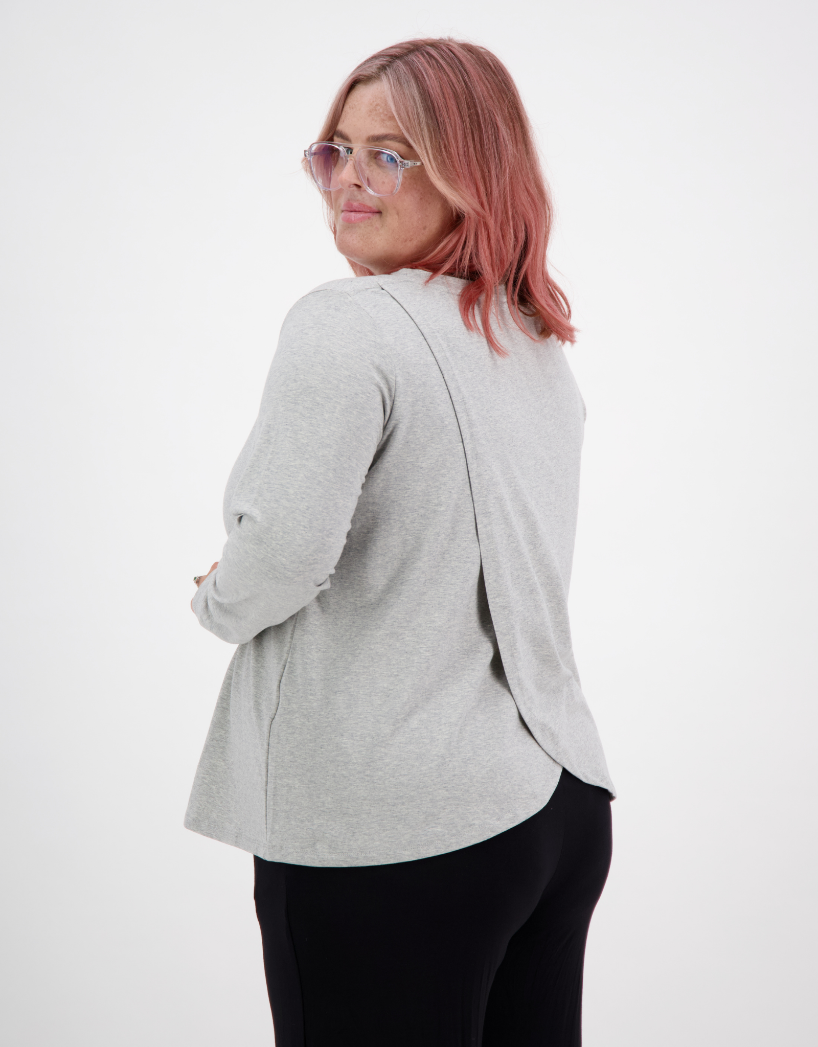 Long Sleeve Leaf Back T-Shirt shown from behind, featuring a stylish grey fabric with unique split back design, styled on a model against white background. Casual yet elegant wardrobe essential with modern tailoring and comfortable fit.
