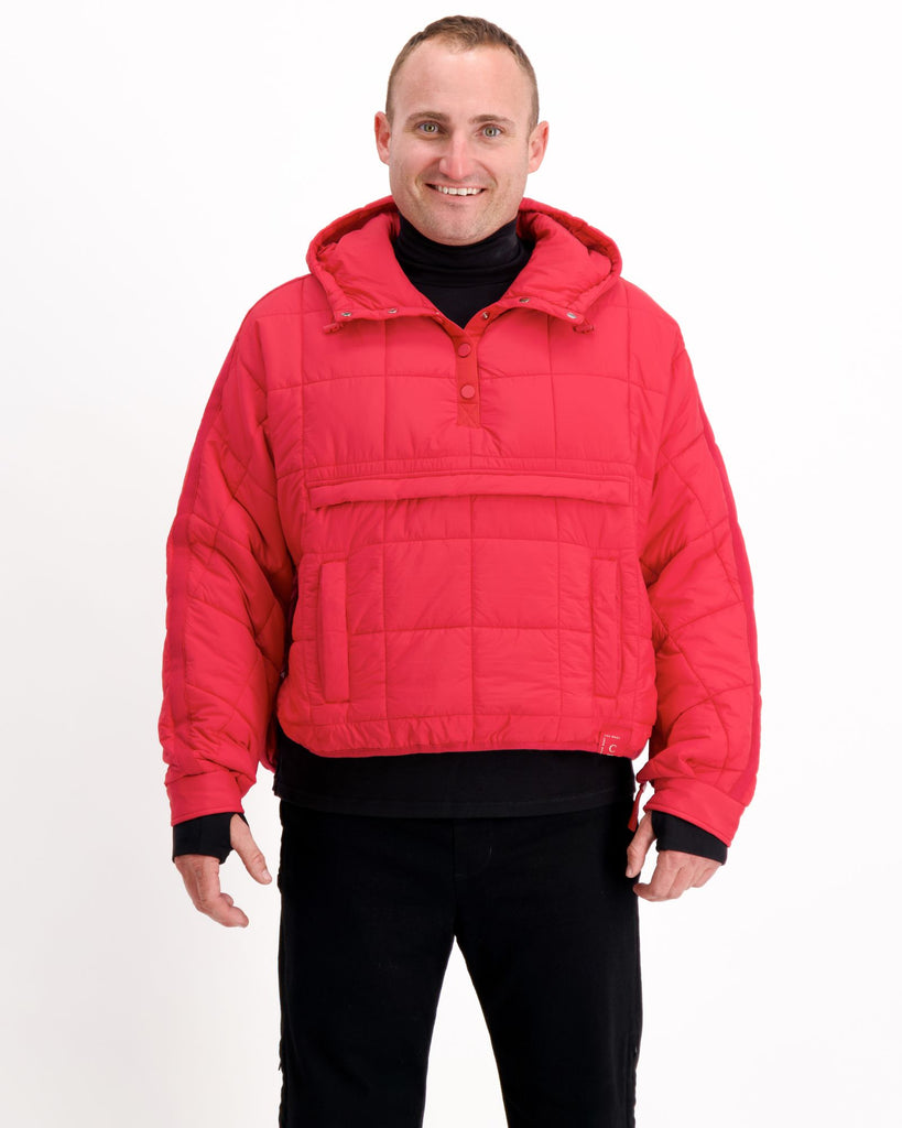 Standing male is wearing a magenta red puffer jacket over black pants. Christina Stephens Adaptive Clothing Australia.