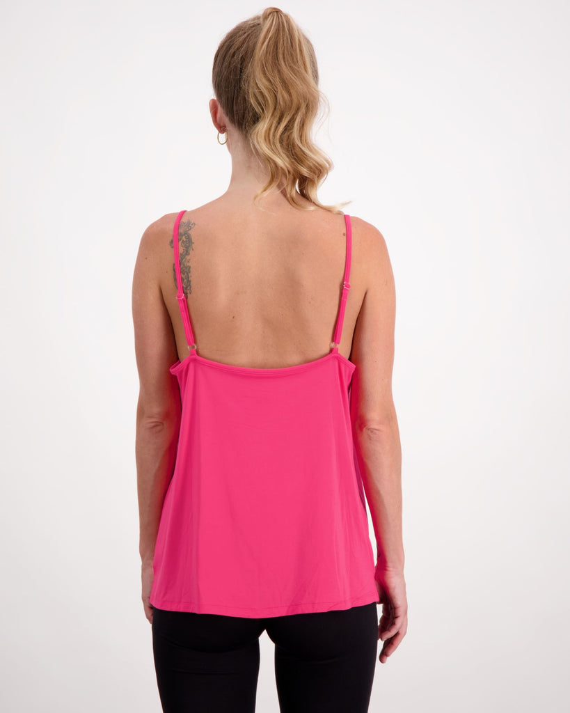Blonde woman wearing a pink camisole top and black pants. Christina Stephens Adaptive Clothing Australia. 