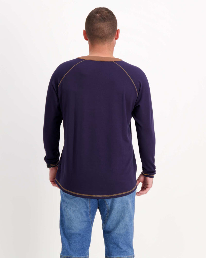 Standing male is wearing a bamboo long sleeve raglan style t-shirt with jeans. Christina Stephens Adaptive Clothing Australia.