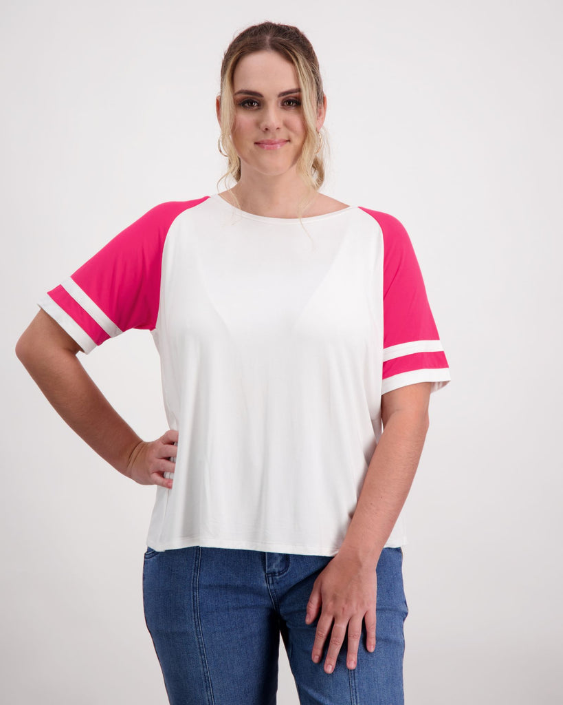 Woman with a prosthetic limb is wearing a white and pink raglan t-shirt. Christina Stephens Adaptive Clothing Australia. 