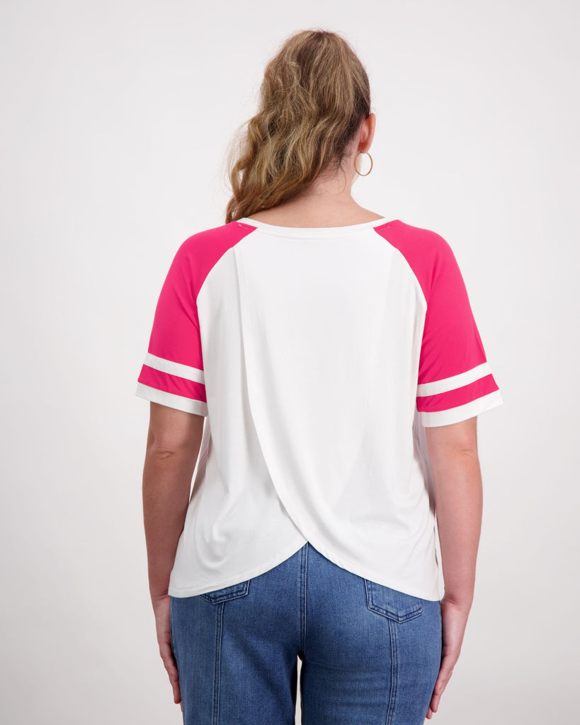 Woman with a prosthetic limb is wearing a white and pink raglan t-shirt. Christina Stephens Adaptive Clothing Australia. 