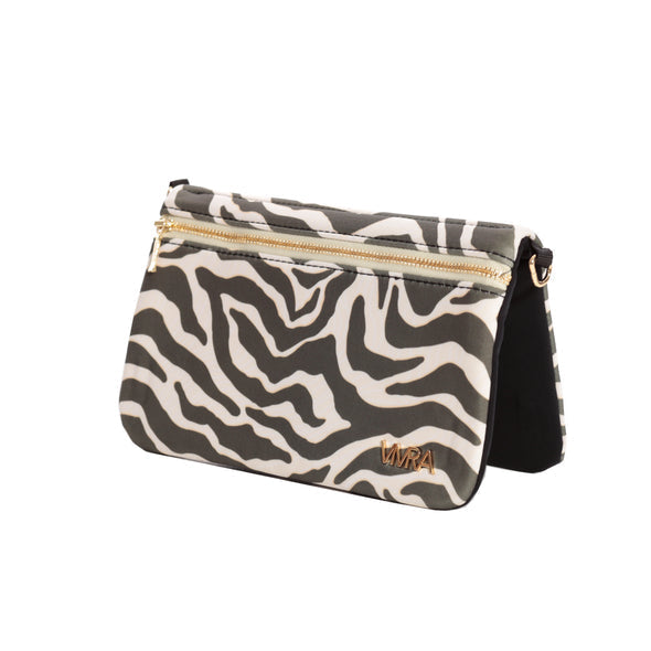 The VIVRA 'Chic' waist bag with a zebra print pattern and gold zipper detailing, featuring a brand emblem in gold that says, 'Vivra', angled upright against a white backdrop.