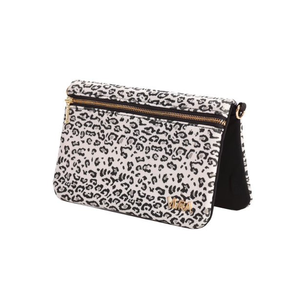The VIVRA 'Chic' waist bag with a black and white leopard print pattern and gold zipper detailing, featuring a brand emblem in gold that says, 'Vivra', angled upright against a white backdrop.