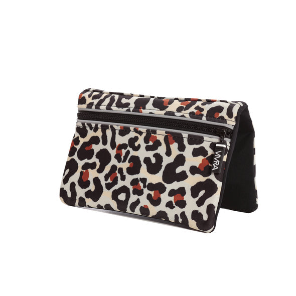 The VIVRA ‘Vivid’ waist bag in a bold leopard print pattern in shades of black, beige, and burnt orange, featuring a black zipper and a brand tag that says, ‘Vivra’, set against a white background.