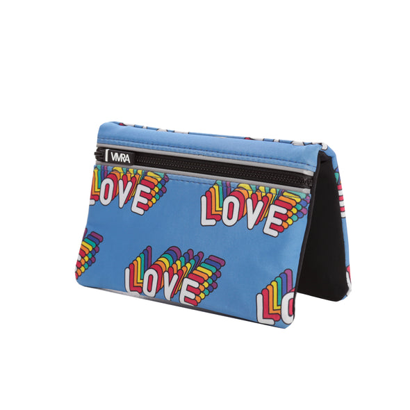 The VIVRA ‘Vivid’ waist bag in a vibrant blue adorned with colourful, rainbow-patterned 'LOVE' text, a black zipper, and the brand tag that says, ‘Vivra’, set against a white background. 