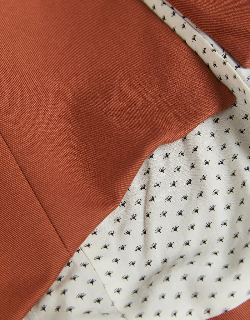Image of red brick cotton drill fabric and contrast lining with black and white fans. Christina Stephens Adaptive Clothing Australia. 