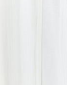 Essensual PJ Top in pure white fabric, featuring a soft, flowy texture with subtle vertical seam detail. This elegant sleepwear piece showcases a minimalist design perfect for comfortable nighttime wear.