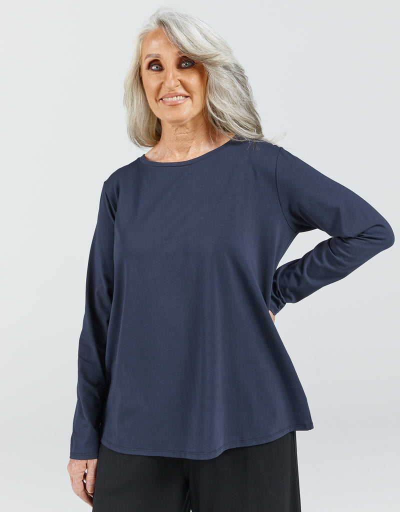 Image of a standing female wearing a long sleeve, navy t-shirt. Christina Stephens Adaptive Clothing Australia. 