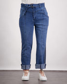 Christina Prosthetic Jeans featured in medium-wash denim with side zippers, rolled cuffs, and innovative tear-resistant fabric. Displayed with white sneakers against a light background, showcasing adaptive design elements and comfortable fit.